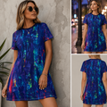 A woman modeling a short-sleeve A-line dress with an abstract watercolor-like print in deep blue, purple, teal, and orange. The image is a collage showing three views: a front view against a textured gray wall with a plant, a back view, and a night street view.