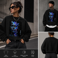 A black crewneck sweatshirt with a large colorful cosmic face graphic on the front, shown in a three-panel collage with a model wearing it, a front view detail, and a back view detail. A feature summary bar is at the bottom.