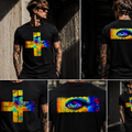 A man modeling a black short-sleeve T-shirt in multiple views, showing a large colorful graphic on the chest and back. The shirt features a yellow and blue cross-like symbol on the front and a matching horizontal multicolor eye design on the back, set against an urban outdoor background.
